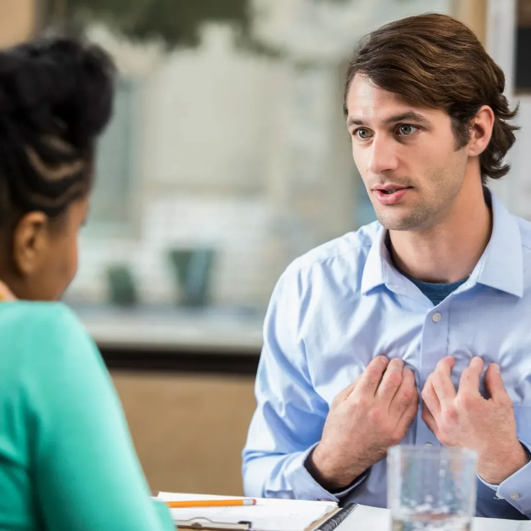 Man speaking honestly in a counseling-style conversation, representing vulnerability, emotional openness, and relationship communication